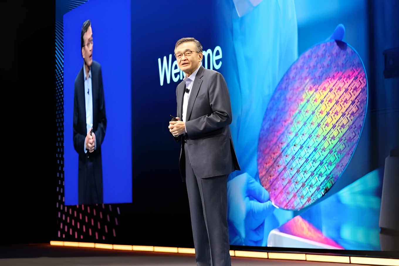 Speaker presenting semiconductor technology on stage.