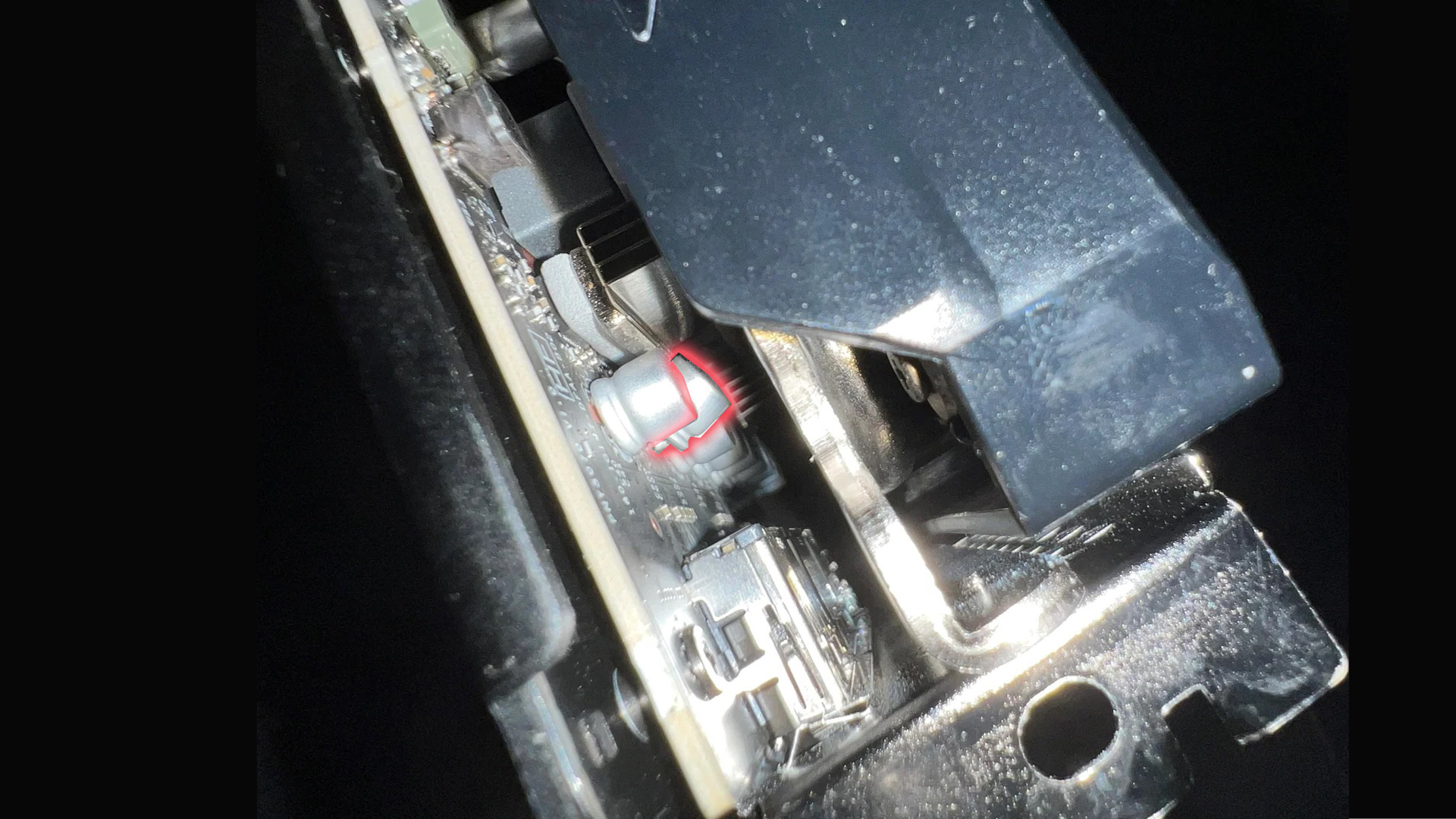 Unbranded circuit board with a red arrow marking a component.