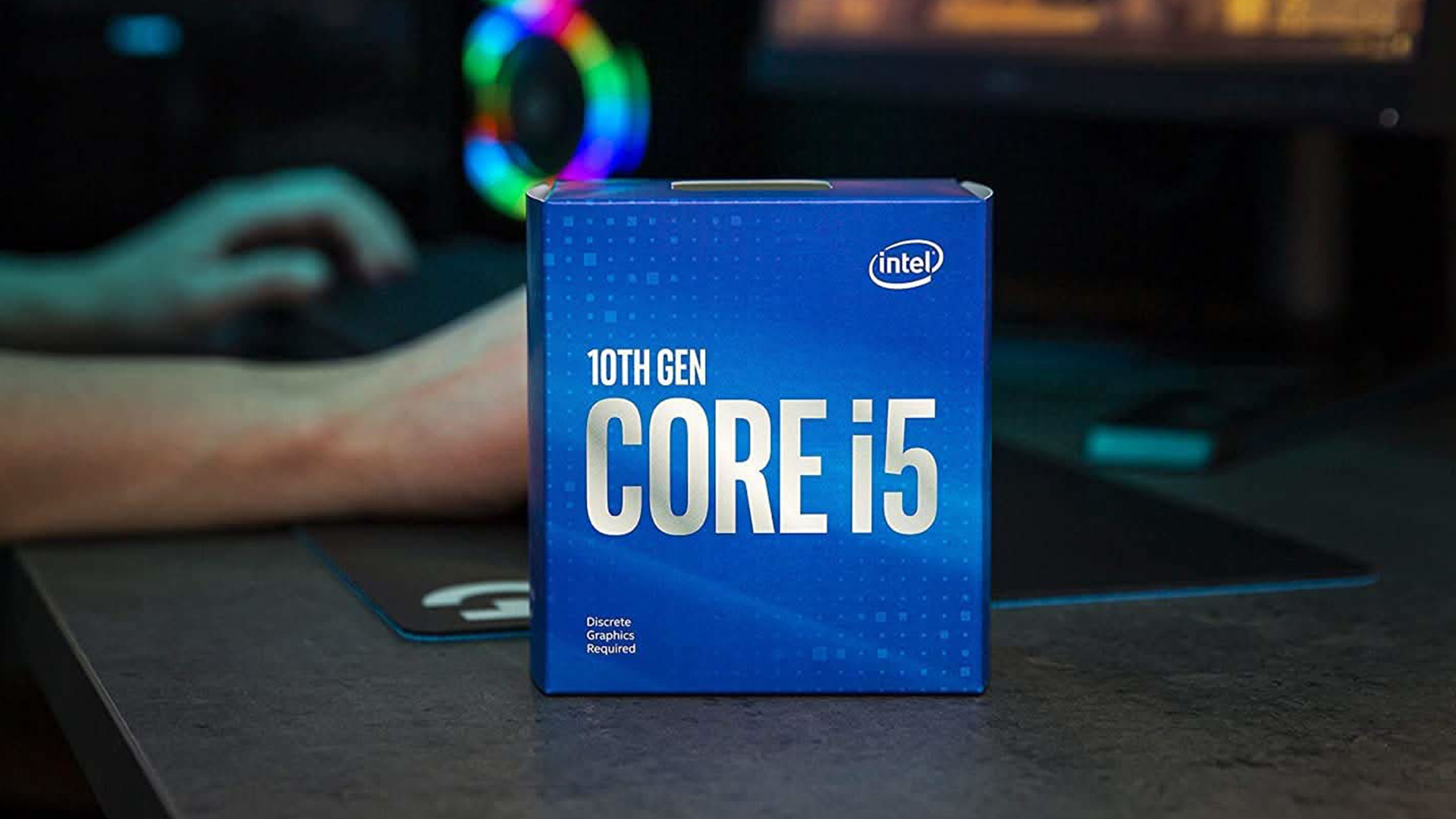 Intel Core i5 10th Gen box on a desk near a gaming setup.