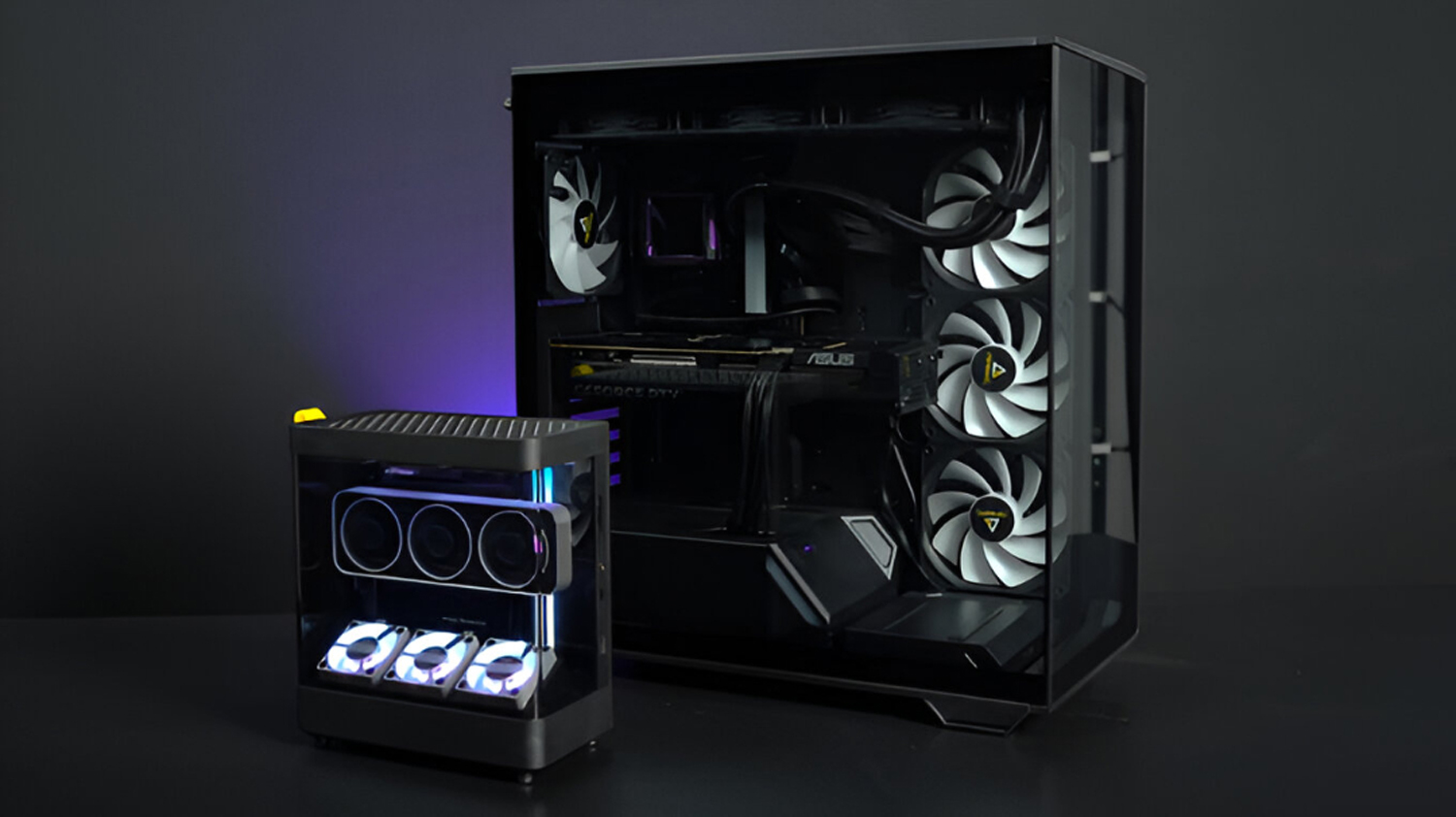 ASUS GPU and small PC case with RGB lighting on a dark background.