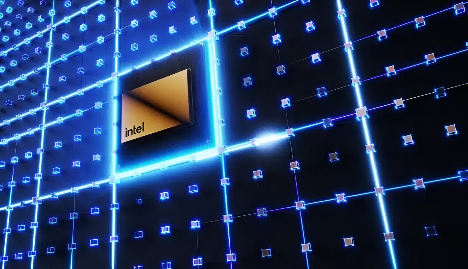 Intel logo on an illuminated grid wall with blue neon lights.