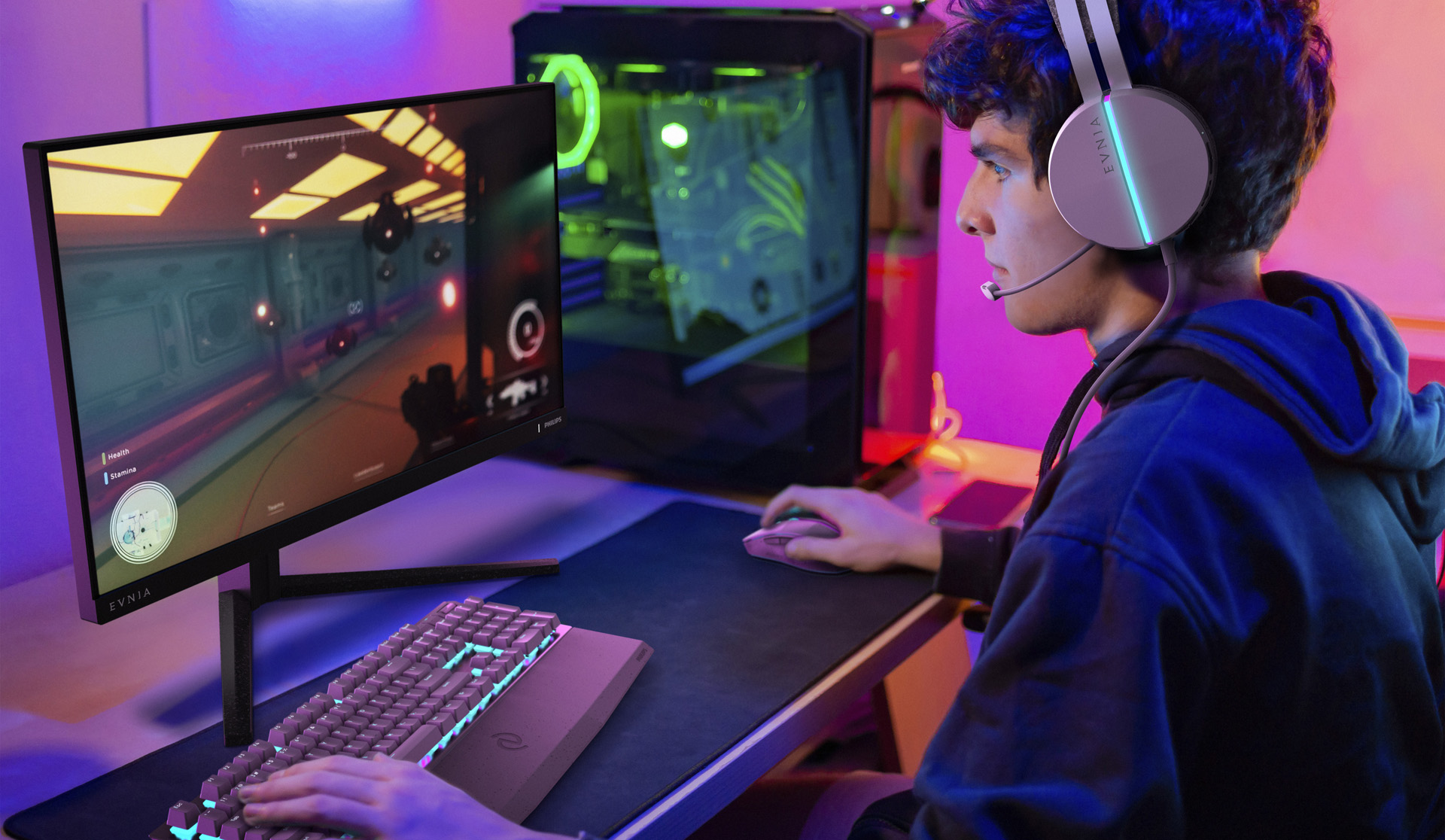 Person gaming on a Philips Evnia monitor with the headset “EVNIA” visible, in a room lit with neon colors.