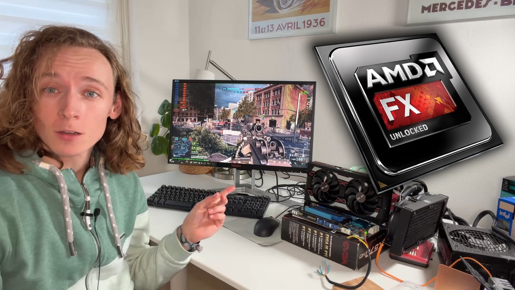 A person points to a screen playing a game with AMD FX UNLOCKED logo and a visible AGON monitor brand.