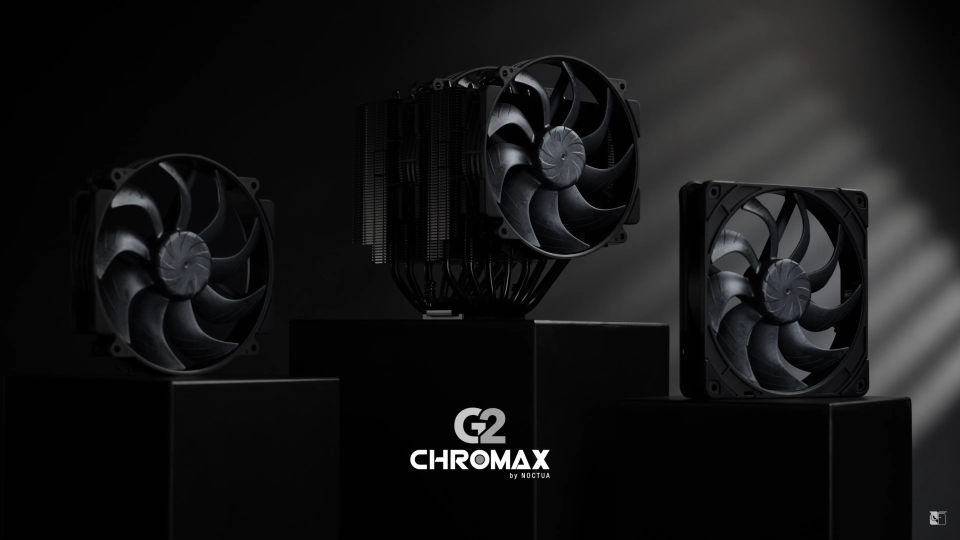 Three black Noctua fans, part of the 'G2 Chromax by Noctua' series, are displayed on dark pedestals.