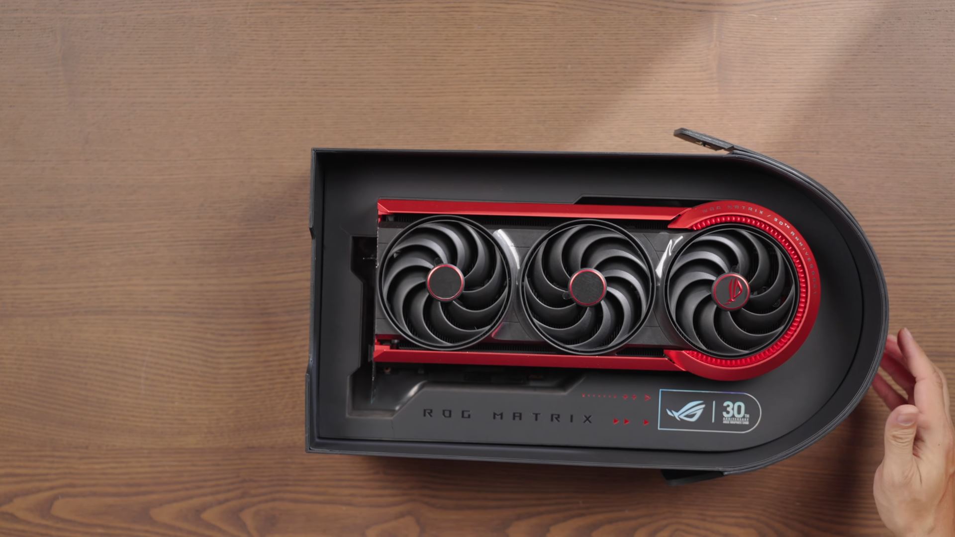 The ASUS ROG Matrix graphics card is displayed in its packaging, featuring a triple-fan design and 'ROG 30th Anniversary' branding.