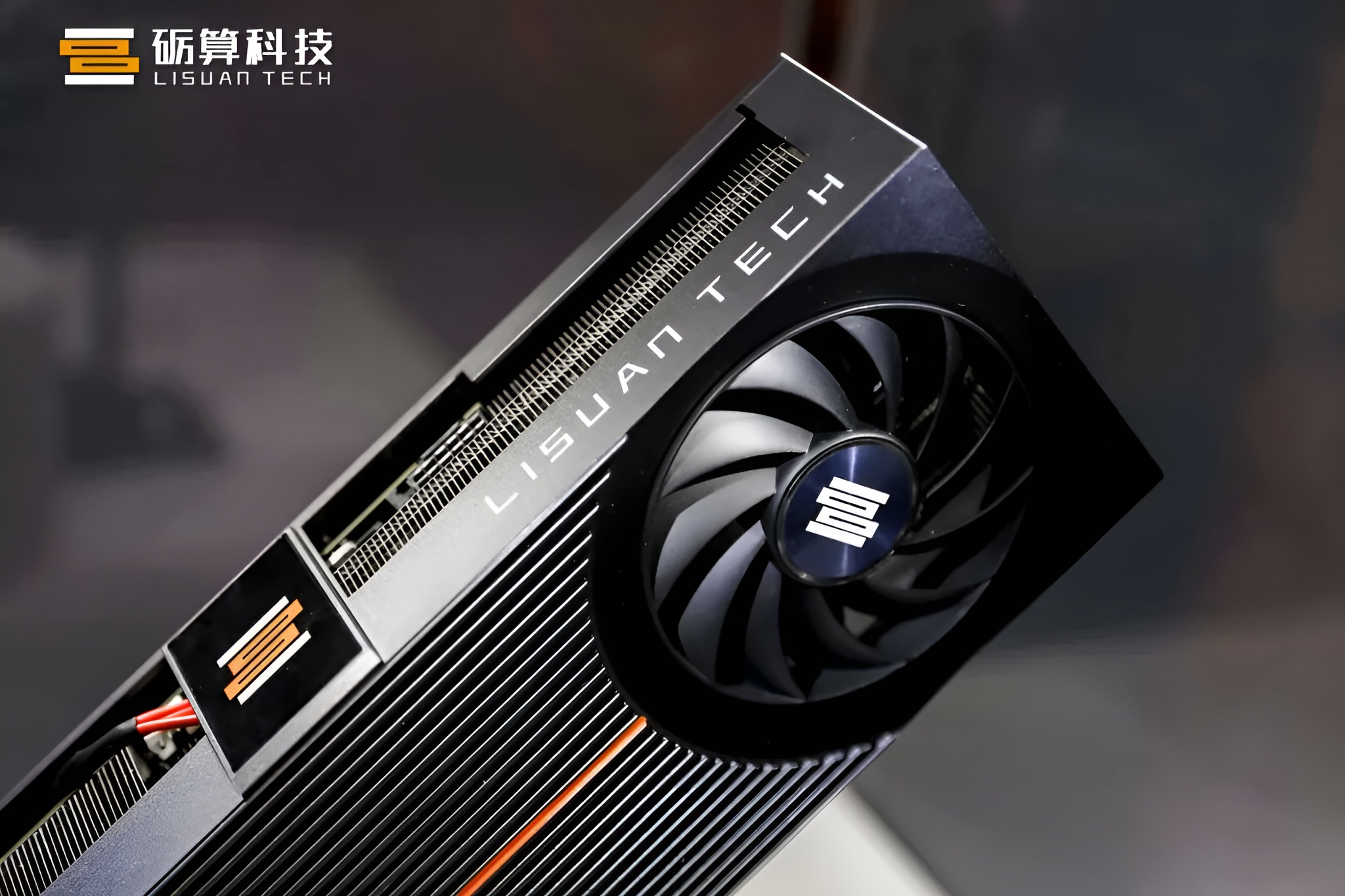 A close-up of a Lisuan Tech graphics card with its branding visible on the fan hub and card edge.