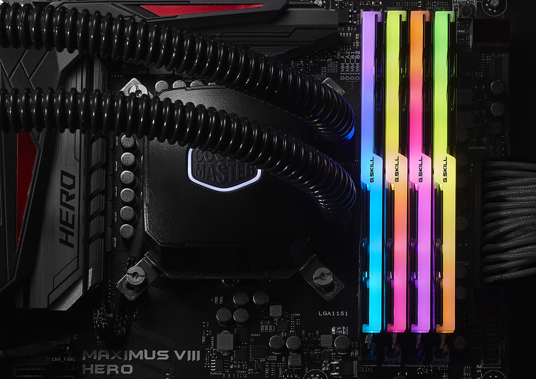Close-up of an ASUS Maximus VIII Hero motherboard with G.Skill RGB RAM and a Cooler Master liquid cooler.