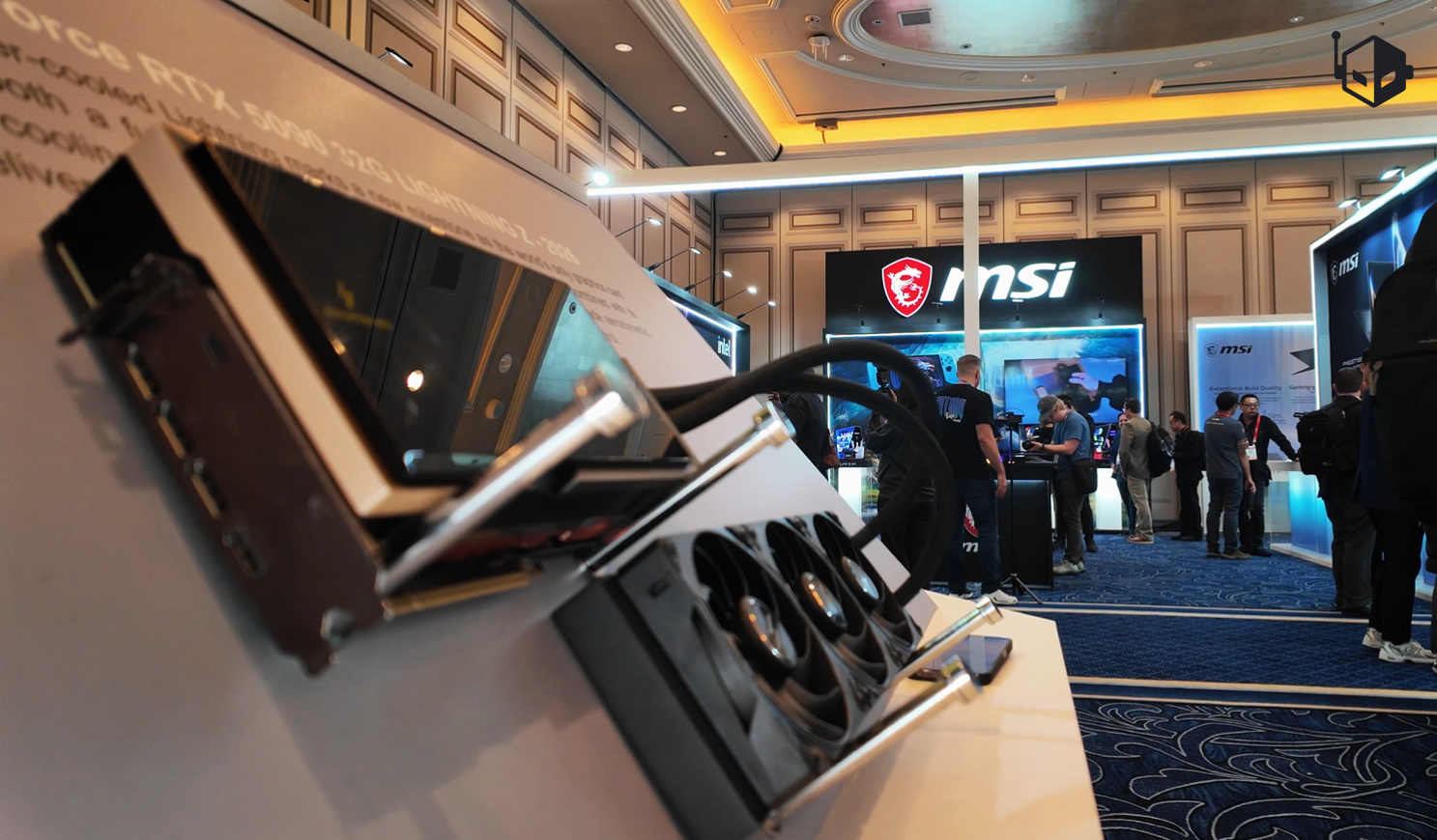 An MSI graphics card display with the logo visible in the background at an MSI exhibition booth.