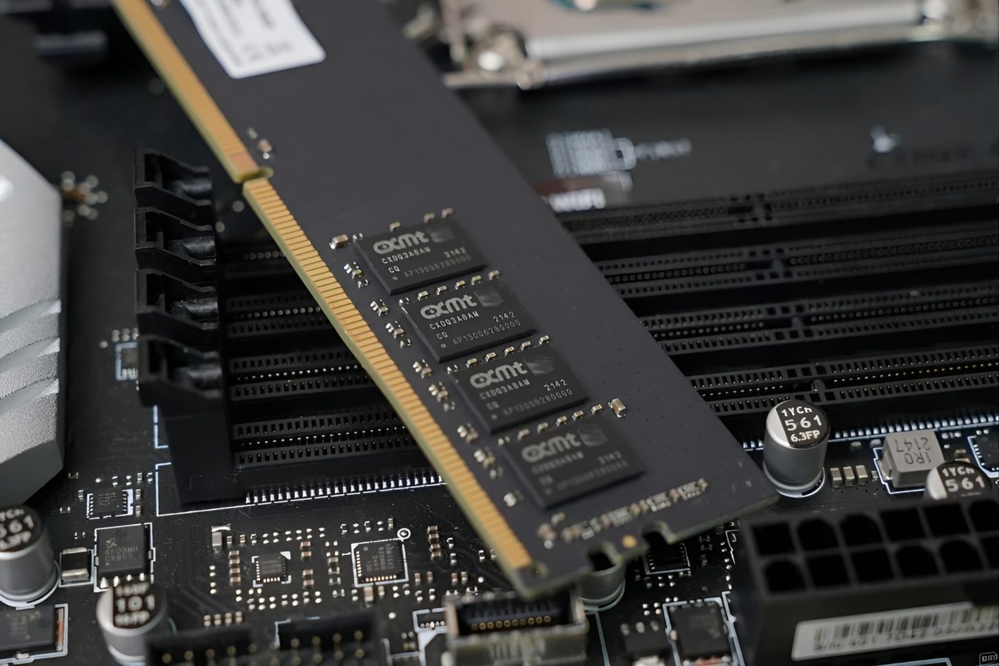 A close-up of a memory module with YMTC branded chips placed on a motherboard.