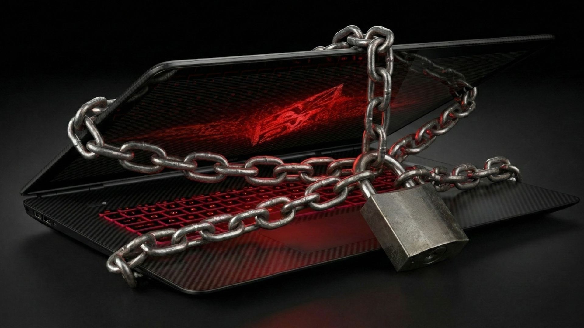 An unbranded laptop with a red glowing screen and keyboard is secured by chains and a padlock.