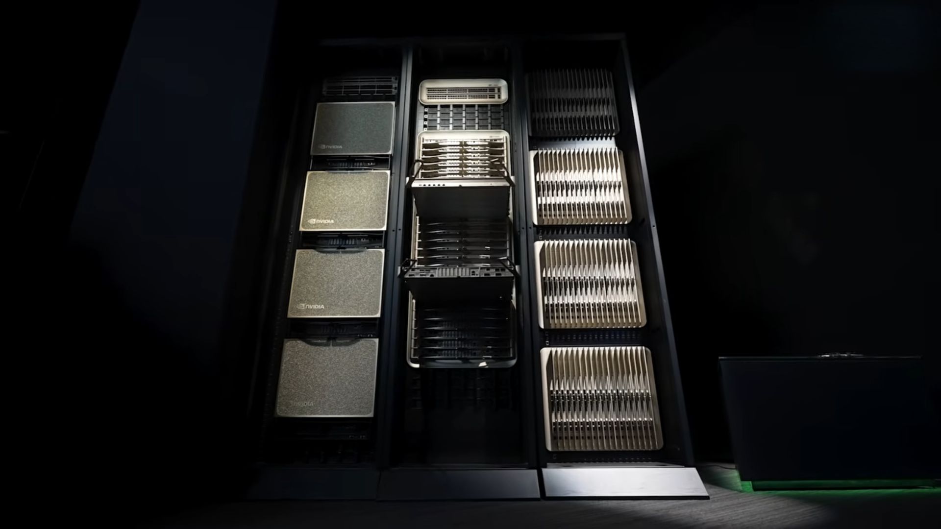 A rack of server units featuring NVIDIA-branded hardware visible in a dimly lit data center setting.