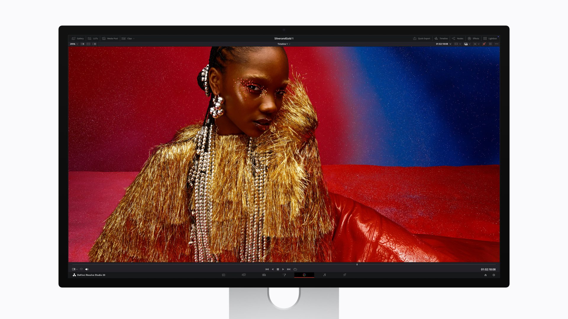 A monitor displays a fashion image being edited in 'DaVinci Resolve Studio 20,' featuring a model in a gold and