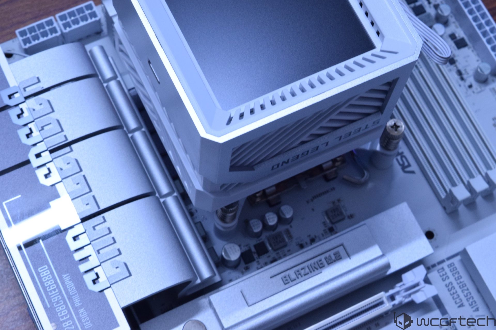 An ASRock Steel Legend motherboard featuring the Blazing M.2 slot and Design Philosophy text on heatsinks.