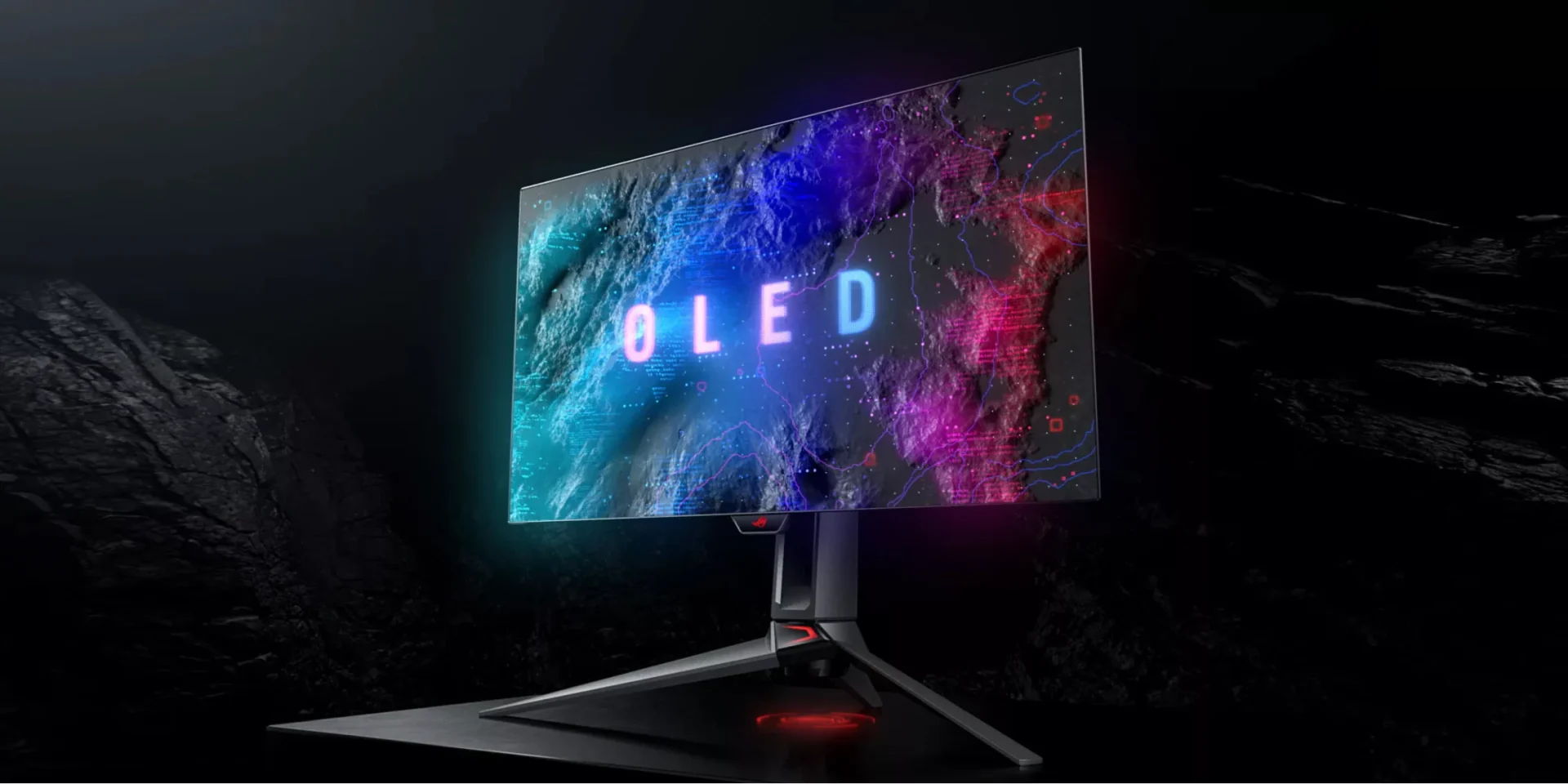 ASUS OLED monitor displaying colorful graphics in a dark room.