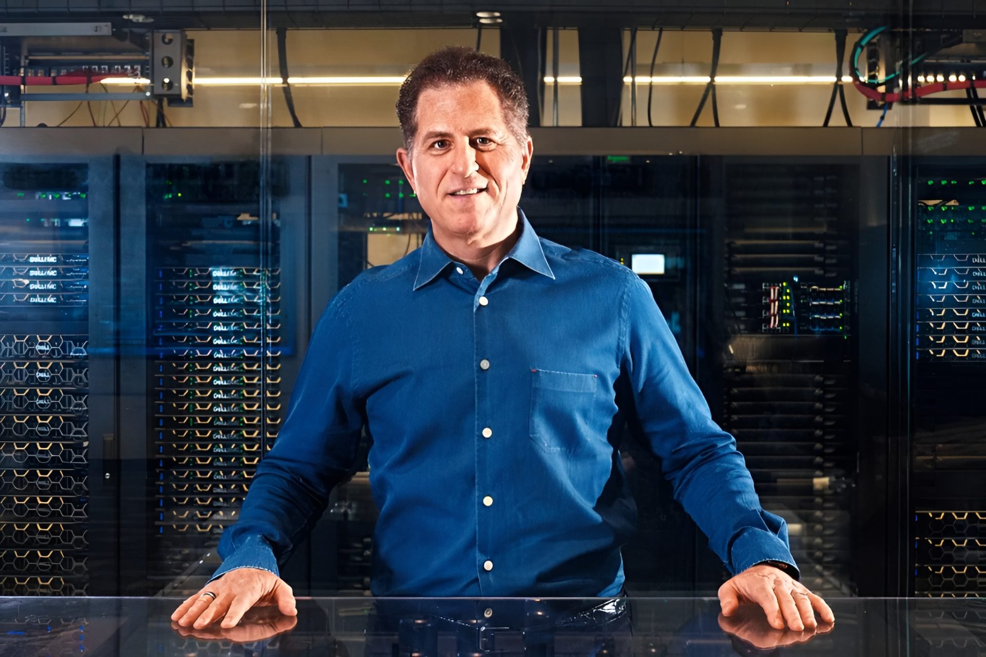 A person in a blue shirt stands in front of Dell EMC server racks in a data center.