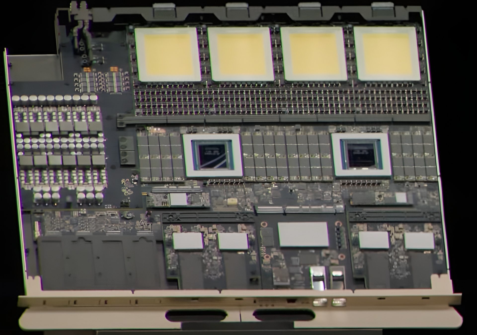A circuit board features two NVIDIA chips at its center with four large yellow components in a row above them.