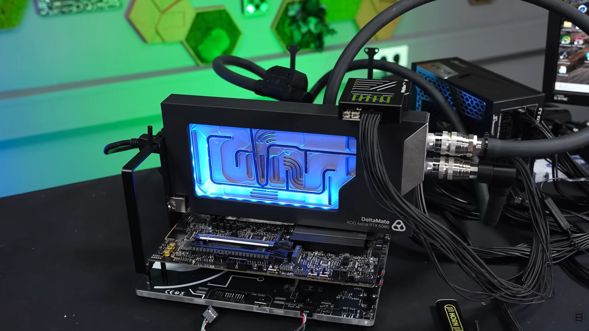 A liquid-cooling setup featuring the DeltaMate ROG Astral RTX 5080 graphics card is displayed on a test bench.