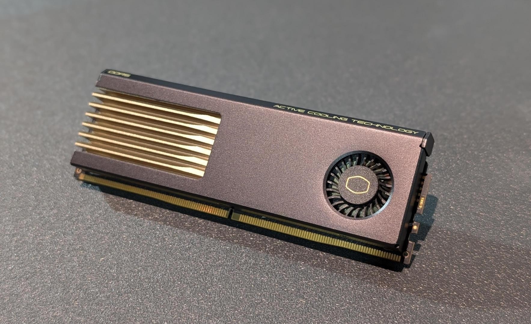 A Cooler Master SSD with 'Active Cooling Technology' is displayed, featuring a built-in cooling fan and gold-colored heatsink fins.