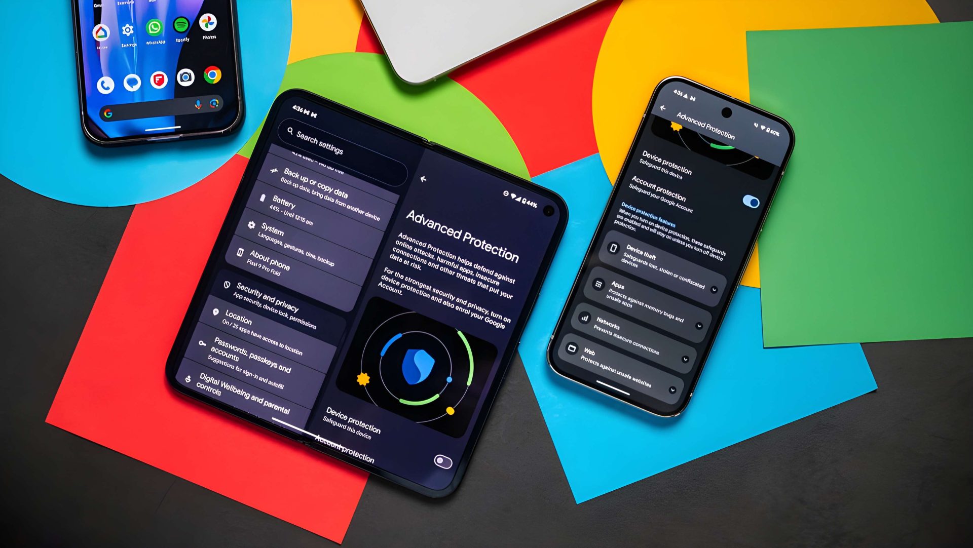 Two smartphones displaying the 'Advanced Protection' feature are placed on a colorful surface, showing different security options.