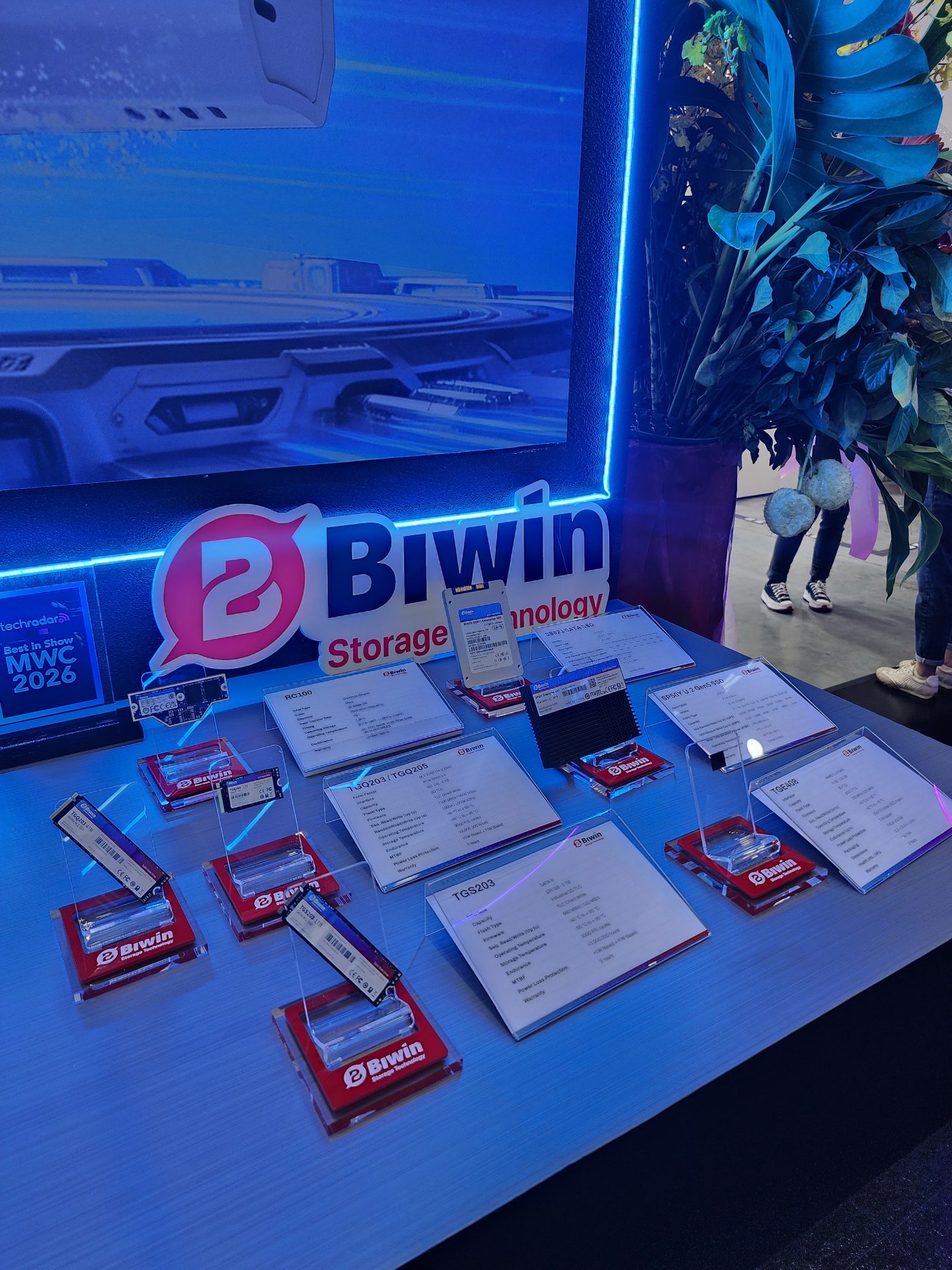A display booth featuring multiple Biwin storage devices, each marked with individual labels, alongside a sign reading