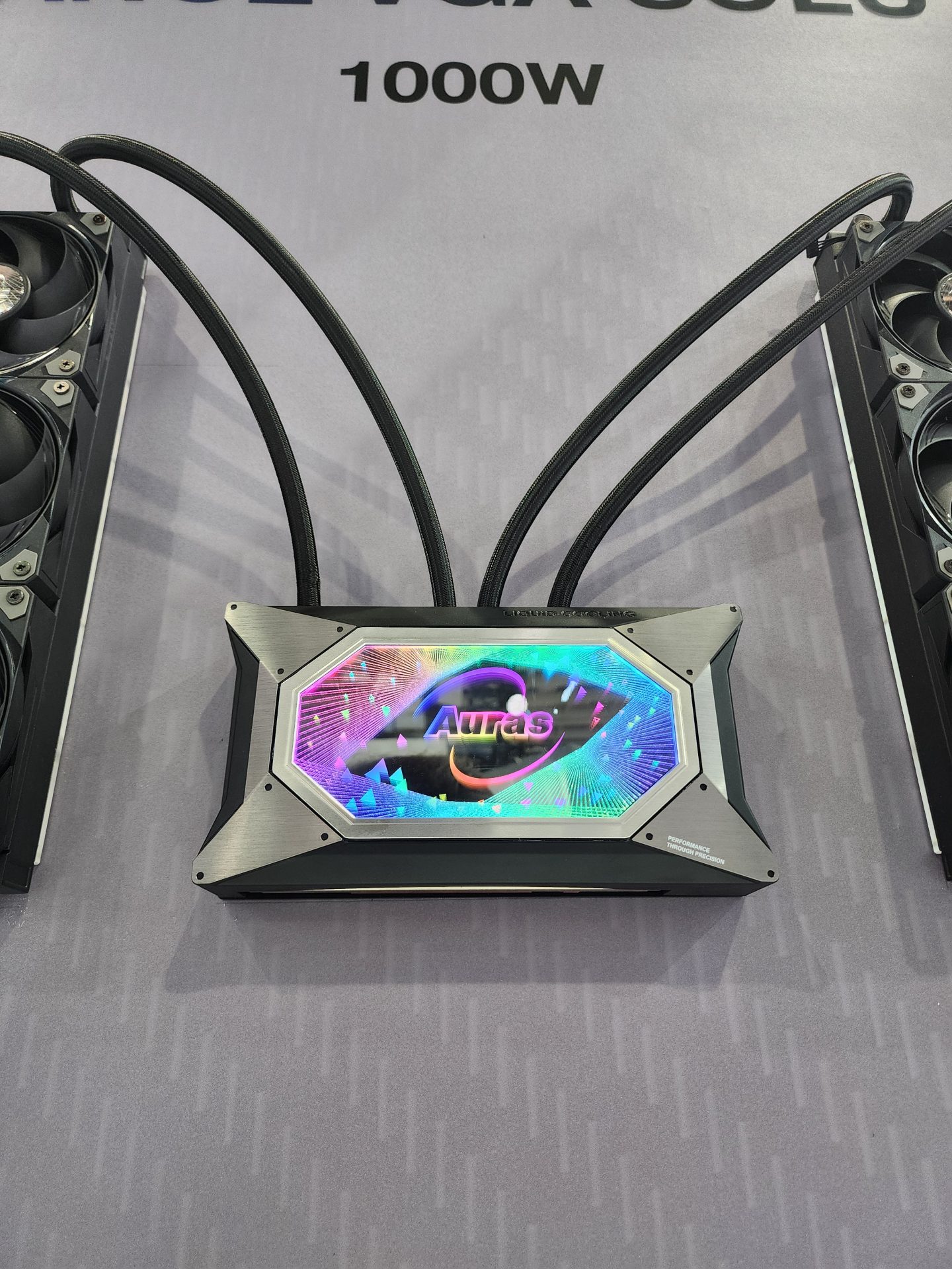 A TechLeo Liquid Magic 1000W PSU with an RGB display featuring the word 'Auras' is connected to cooling fans.