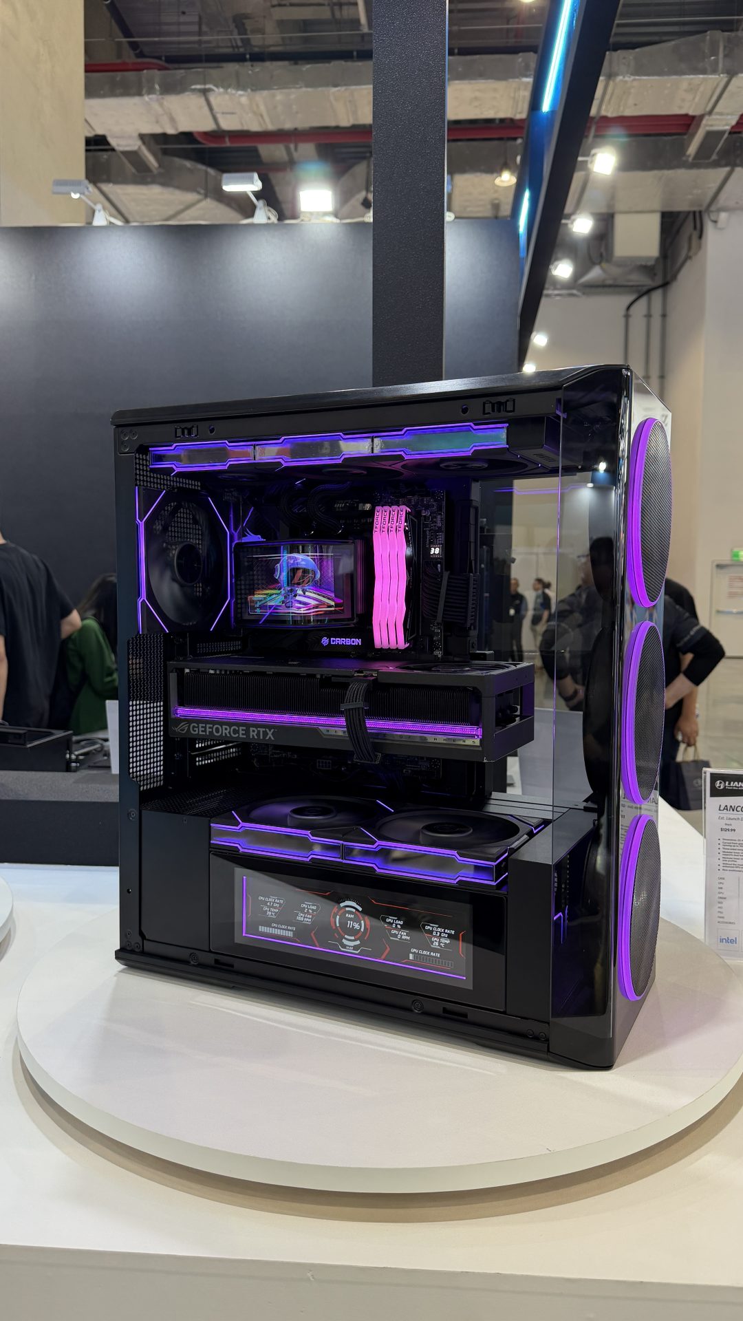 A custom-built gaming PC with RGB lighting is showcased, featuring a GeForce RTX graphics card and a Corsair Carbon CPU cooler.
