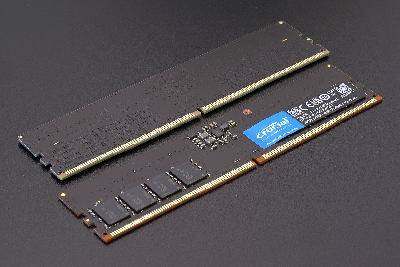 A pair of Crucial RAM sticks labeled as 16GB DDR5-4800 UDIMM, displaying memory chips and circuit details.