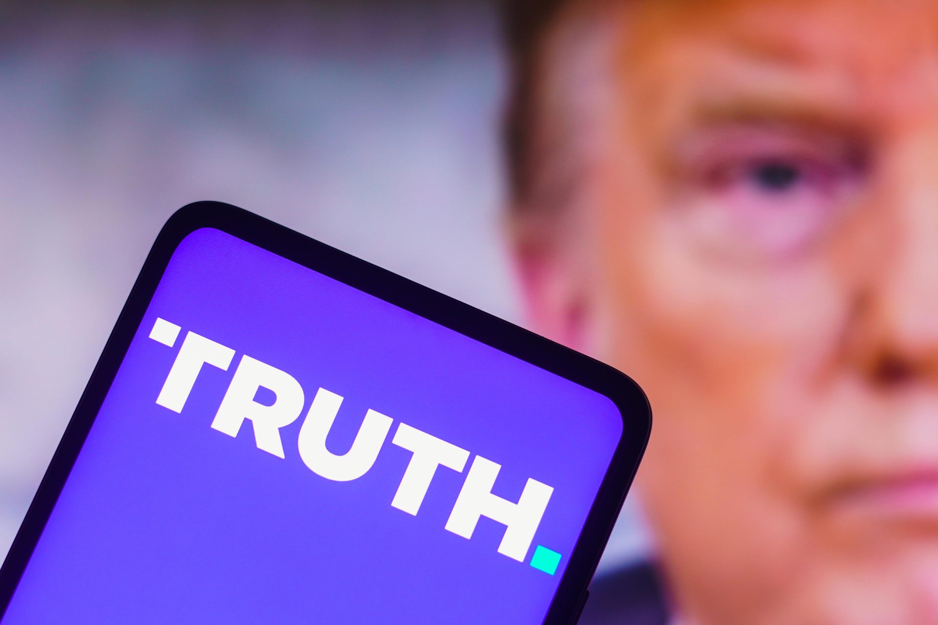 A smartphone screen displays the word 'TRUTH' in bold letters with a blurred face in the background.