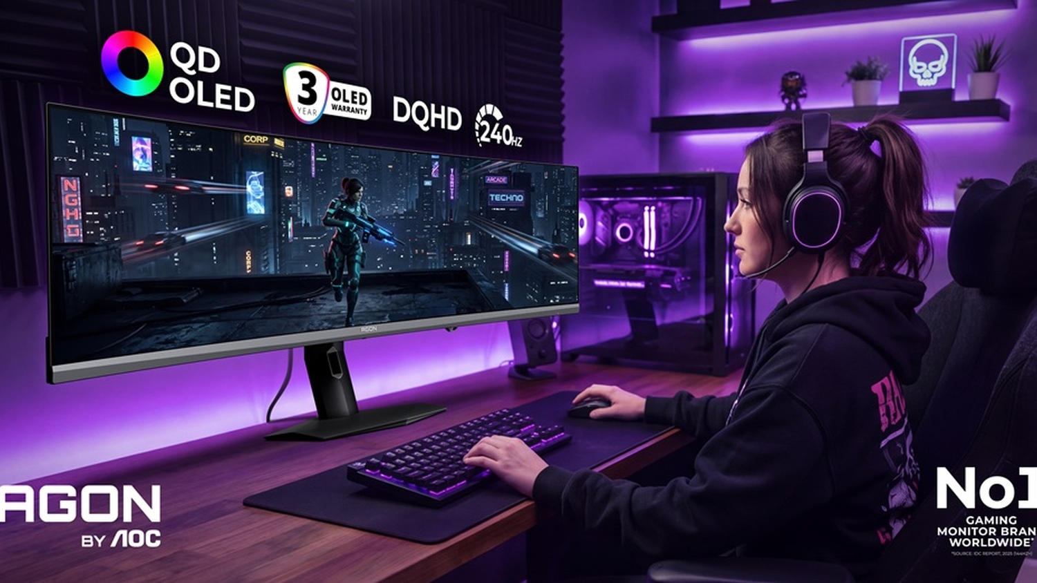 A person wearing headphones sits at a desk using an AOC Agon monitor displaying a game scene, with visible logos for 'QD OLED,' '3 Year OLED Warranty,' 'DQHD,' and '240 Hz' on the wall above.