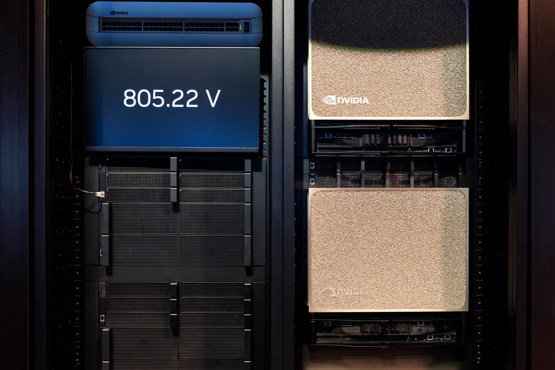 A server rack features NVIDIA hardware with a display indicating '805.22 V' and NVIDIA-branded units installed.