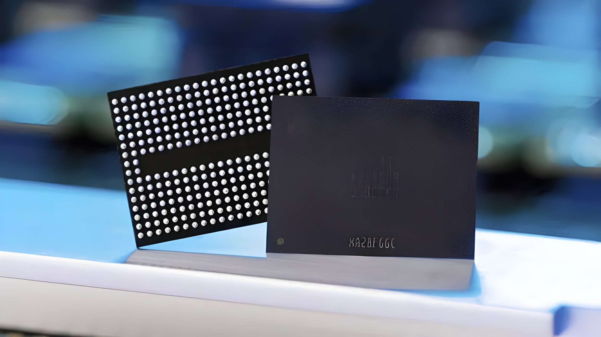 A close-up of a Samsung semiconductor chip with visible circuitry patterning and the code 'KABBGGC'.