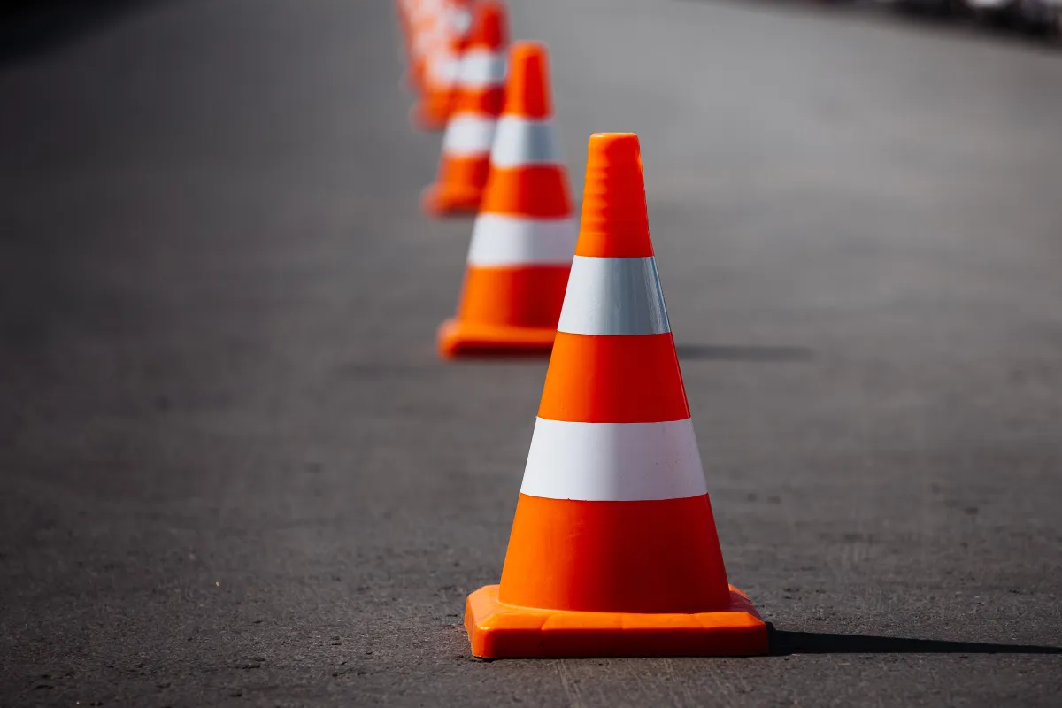 line of orange traffic cones on road