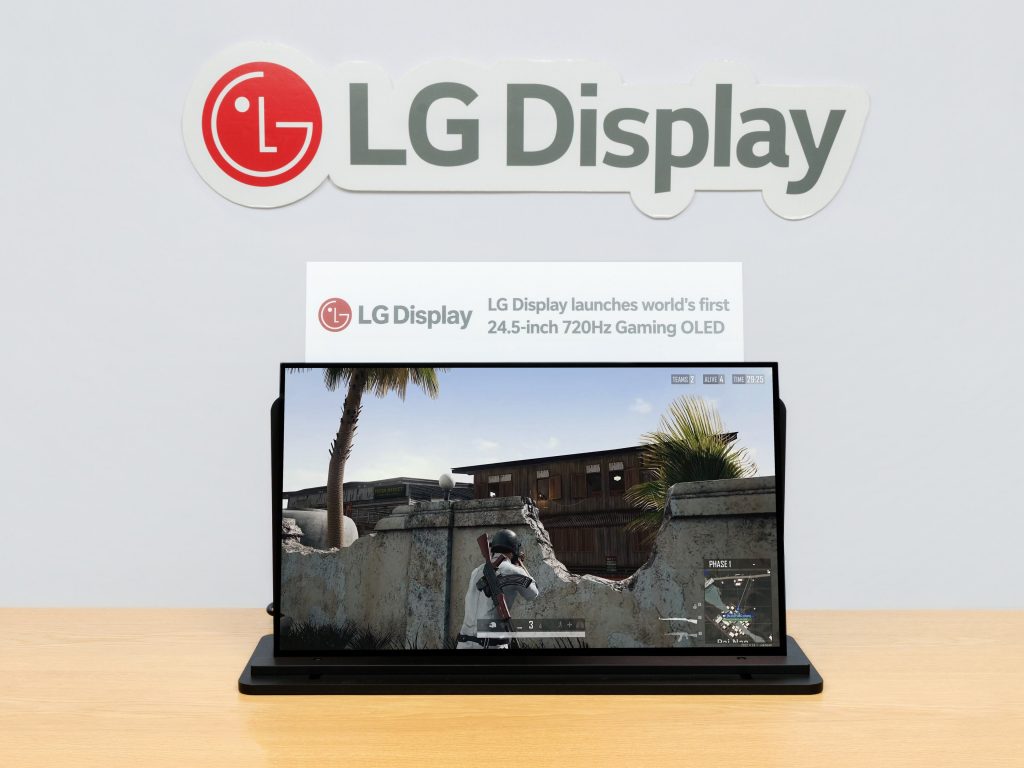 An LG monitor displays a gaming scene under a sign that reads 'LG Display launches world’s first 24.5-inch 720Hz Gaming OLED.'