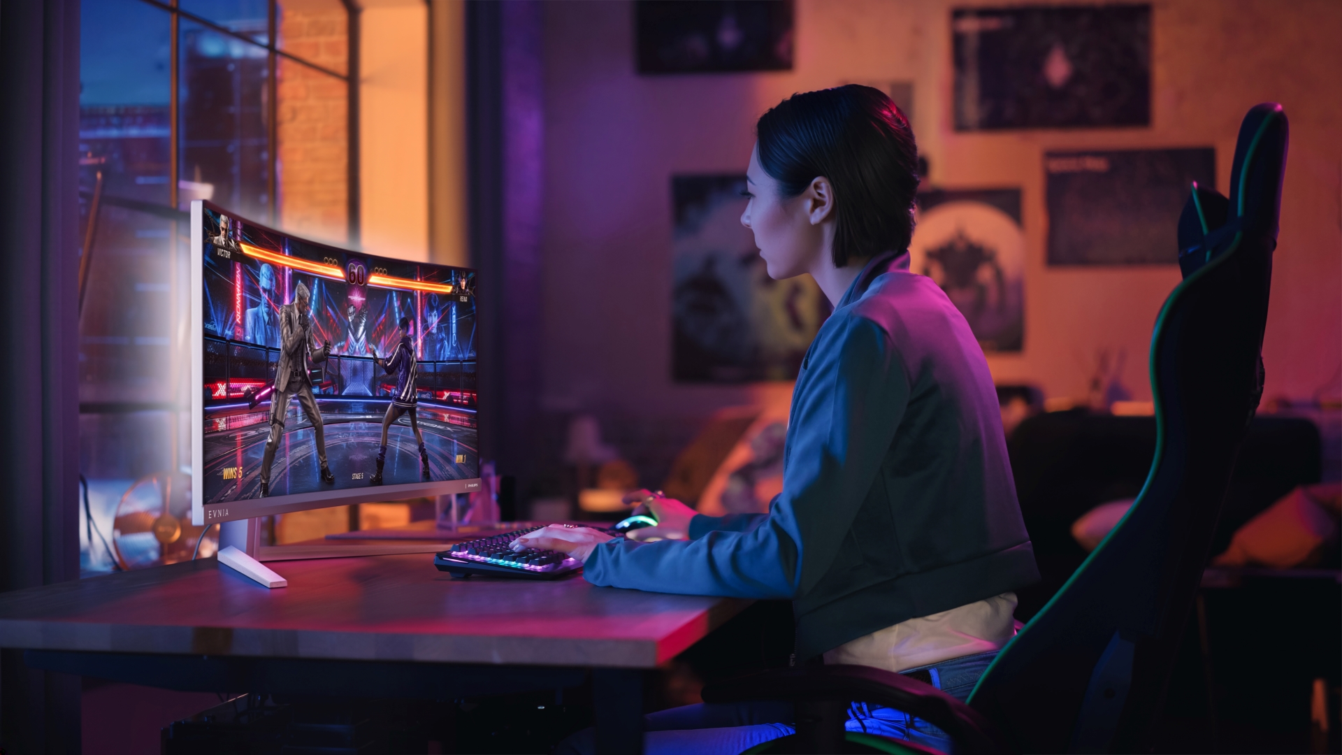 A person playing a fighting game on the Evnia curved monitor with colorful backlit keyboard and mouse in a dimly lit room.