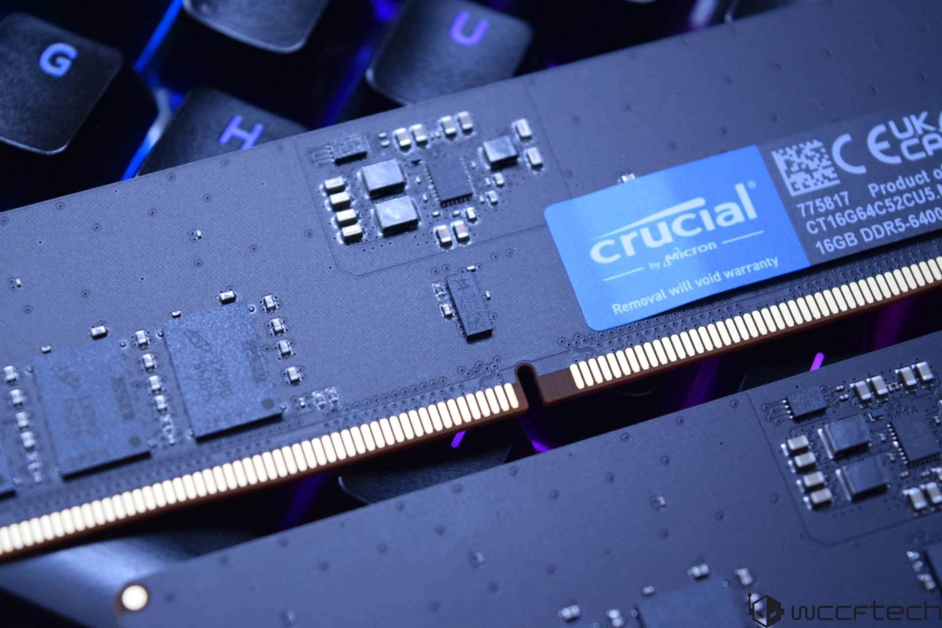 A close-up of Crucial by Micron 16GB DDR5-6400 memory module on a keyboard background.