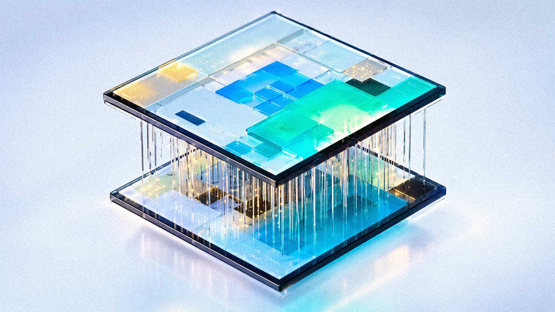 A conceptual two-tiered glass object with embedded multicolored translucent blocks and suspended light strands.